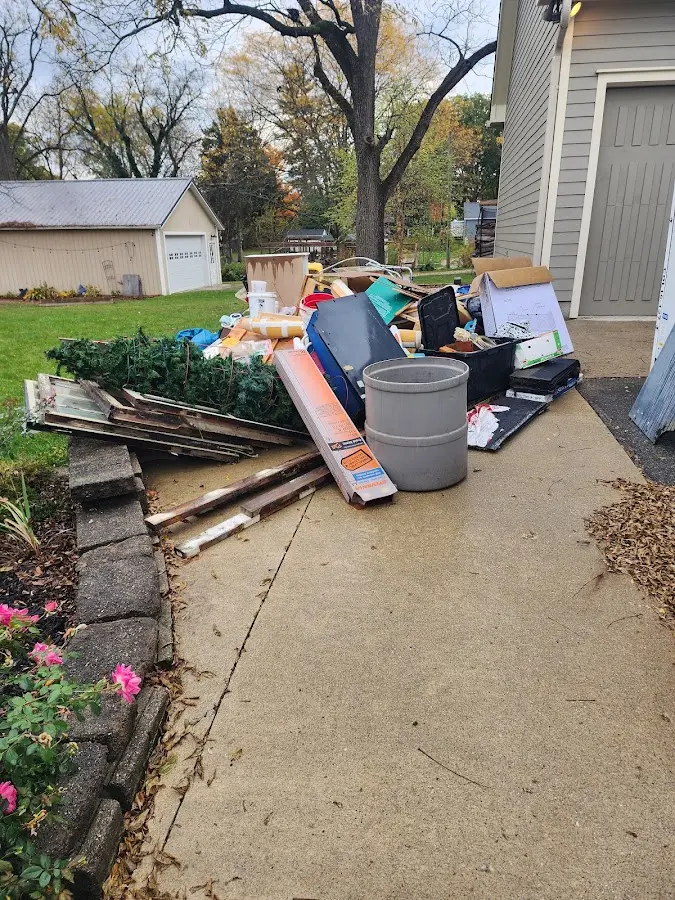 Dumpster being loaded with debris for 12 Yard Dumpster Rental in Burbank